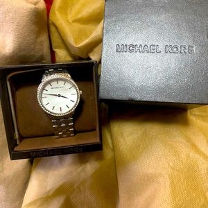Michael Kors woman’s silver watch.